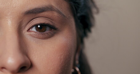 Gentle portrait featuring half of the girl's face against a neutral background, complemented by subtle makeup.