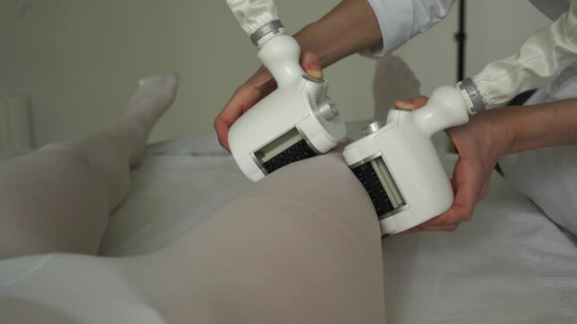 Targeting lymphatic system with rhythmic movements and massage to get rid of waste and toxins 4k video. Young woman is having lymphatic drainage treatment to remove leg swelling.
