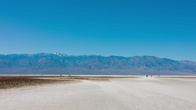Immerse yourself in the stunning views of Badwater Flats and the imposing Black Mountains in Death Valley National Park, California, a testament to nature's grandeur.