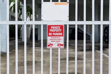 private property no parking sign on a gate