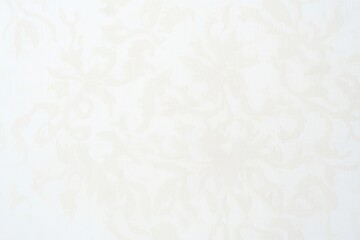 Elegant white damask pattern background in light beige. Floral design creates ornate texture suitable for interior design. Classic vintage style with subtle embossed pattern. Suitable for wallpaper