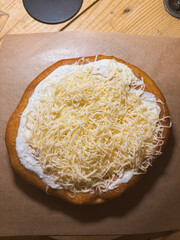 Hungarian langos with cream and cheese, Hungarian dishes, European fast food