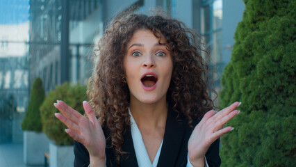Outdoors business portrait Caucasian amazed shocked young girl woman looking at camera open mouth...