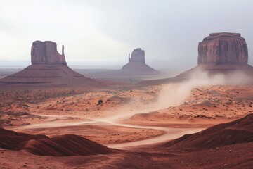 Naklejka premium A dust storm sweeping across a desert landscape, with sand swirling and reducing visibility.