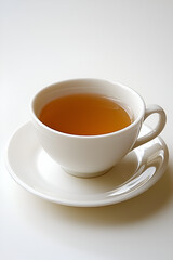 A steaming cup of tea on a saucer, perfect for a relaxing moment.