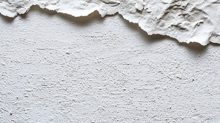 Peeling white paint on textured wall.