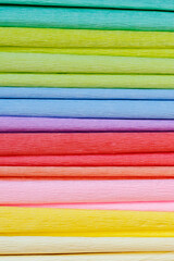 Multicolored crepe paper in pastel soft shades close-up. Handicrafts with children as a type of family recreation. Materials for handicrafts. Spring vibe
