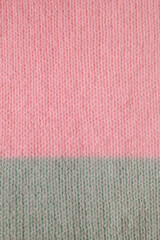 Fototapeta premium knitted fabric from wool and acrylic yarn in simple stocking stitch in pink and turquoise colors. Knitting as a way to relax and earn extra money.