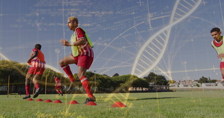 DNA strand and scientific data image over soccer players training on field © vectorfusionart