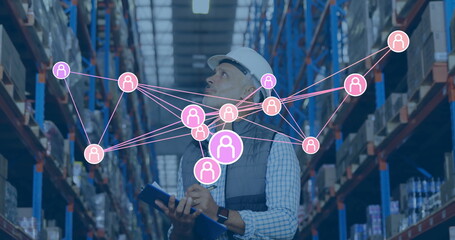 Network of connections image over warehouse worker inspecting inventory