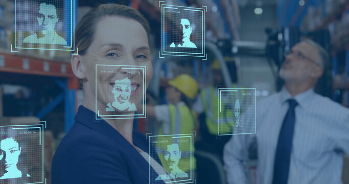 Facial recognition image over warehouse workers and smiling businesswoman