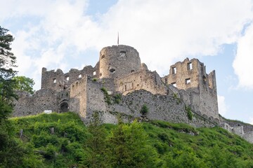 View of an old dilapidated medieval castle on top of a mountain in the Austrian Alps. Mountain landscape with a castle.