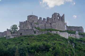 Fototapeta premium View of an old dilapidated medieval castle on top of a mountain in the Austrian Alps. Mountain landscape with a castle.