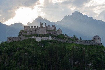 View of an old dilapidated medieval castle on top of a mountain in the Austrian Alps. Mountain...