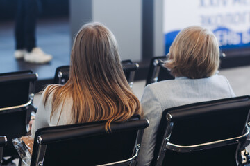 Conference with female audience, the symposium meeting, participants attendees in room hall listen...