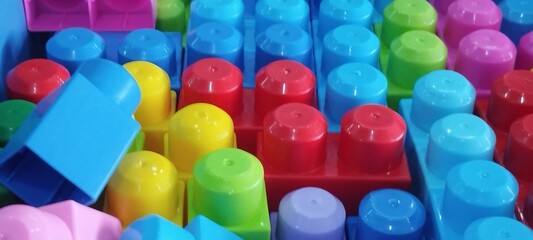 Colorful plastic toys for children in a box, close-up