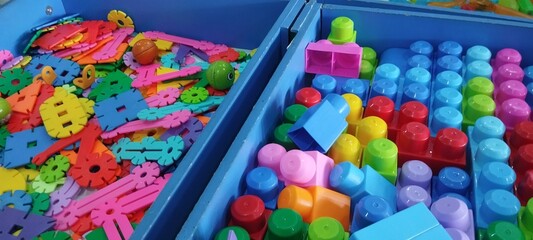Colorful plastic building blocks on the floor. Close-up.