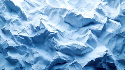 Obraz premium Abstract background of crumpled blue paper.