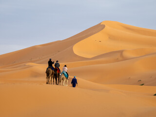 Tourisdts on camels in the nSahara Desert Sand Dunes