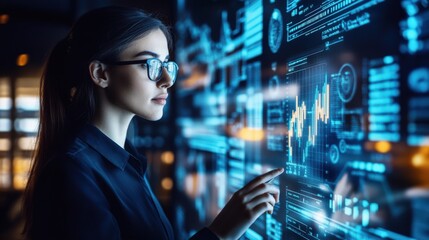 A woman is looking at a computer screen with a lot of numbers and graphs