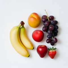 Flat lay of fresh fruits bananas, peaches, grapes, strawberry, and plum on white background.