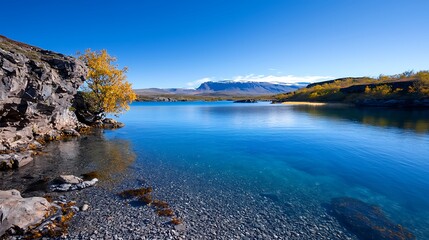 Obraz premium Serene Mountain Lake with Crystal Clear Water and Autumn Colors
