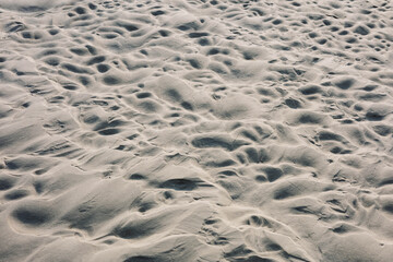 Patterns of Serenity: A Close-Up on Gentle Sand Textures Captured at a Tranquil Beach, Reflecting Nature's Artistry in Soft Hues and Intricate Details of Underground Layers.