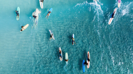 Drone Aerial View of Surfers Riding Waves in Hawaii Sea with Surfboards in the Blue transparent...