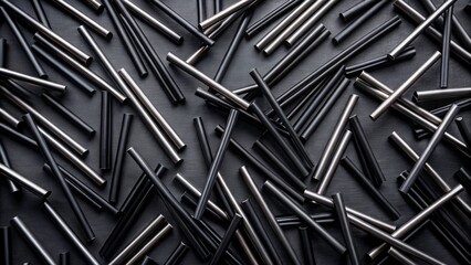 Low Light Flat Lay of Black Plastic Straws for Takeaway Drinks in Geometric Arrangement on Dark Background