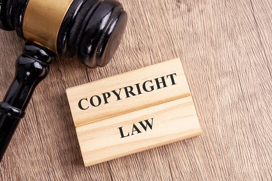 copyright law text in the wood block and judge gavel on the table 
