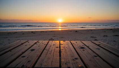 A beautiful view of  a wooden table near the beach and the sunset behind it.