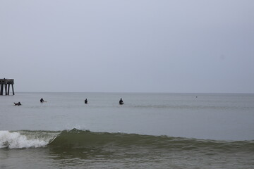 Ocean front with a sandbar and a fishing pier at Jacksonville Beach, Florida. 