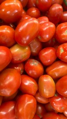 a pile of fresh tomatoes at the market