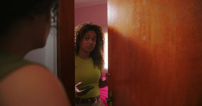 Teenage daughter mockingly resists mother&rsquo;s demand to hand over her phone, highlighting family struggles with parenting, technology addiction, and generational conflicts
