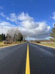 Fototapeta premium Straight, wet road just after the rain - Route rectiligne et humide juste après la pluie