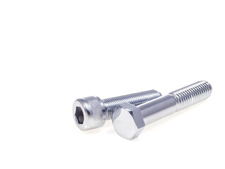 Two shiny metal bolts with different heads lying on a white background chrome plated