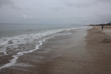 Ocean front with a sandbar and a fishing pier at Jacksonville Beach, Florida. 