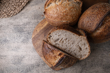 Golden-Crusted Artisan Sourdough Bread on a Rustic Wooden Table.