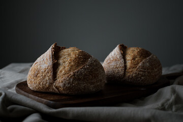 Artisan Batard Sourdough healthy Bread. Open crumb high hydration Sourdough french country bread set on dark background.