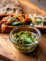 Pesto Sauce with Rustic Sourdough Bread on Wooden Table.