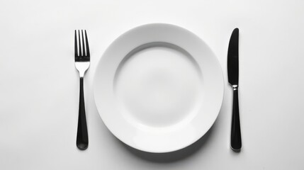 A simple place setting with an empty plate, fork, and knife on a white background, ready for a meal