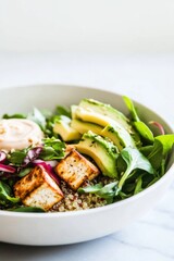Colorful quinoa salad with roasted tofu and creamy tahini dressing
