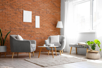 Stylish armchairs and coffee table in interior of living room