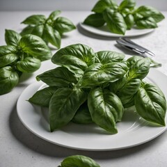 A cluster of fresh basil leaves stacked neatly on a white plate.ate.