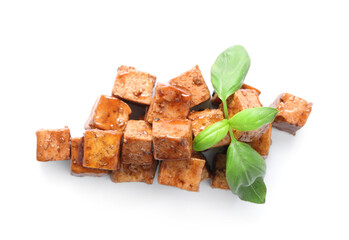 Pieces of fried tofu cheese with soy sauce and basil on white background