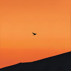 Obraz premium A Single Silhouette in a Fiery Sky: A lone bird takes flight against a breathtaking sunset, casting a dark silhouette against a fiery orange sky. The image evokes a sense of freedom and solitude.