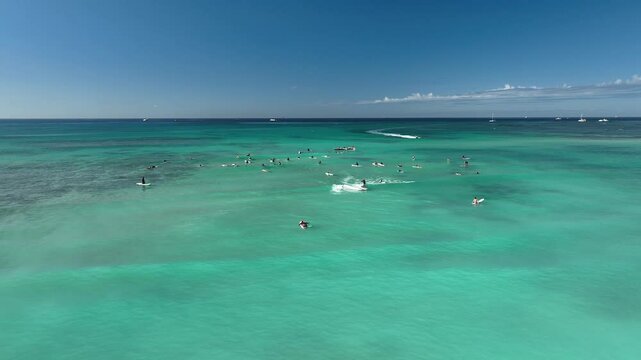 Drone Aerial View of Surfers Riding Waves in Hawaii Sea with Surfboards in the Blue transparent Ocean 