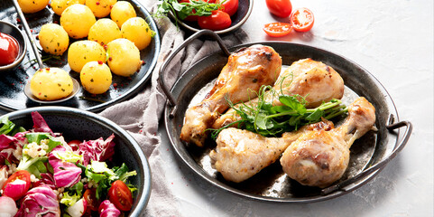 Baked chicken legs with salad and potatoes