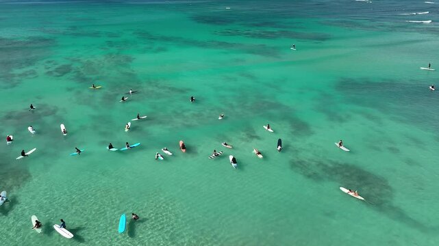 Drone Aerial View of Surfers Riding Waves in Hawaii Sea with Surfboards in the Blue transparent Ocean 