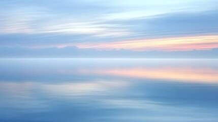 A peaceful sky at dusk, painted in gentle pinks and blues, casting a soft glow over the calm waters that stretch out toward the horizon